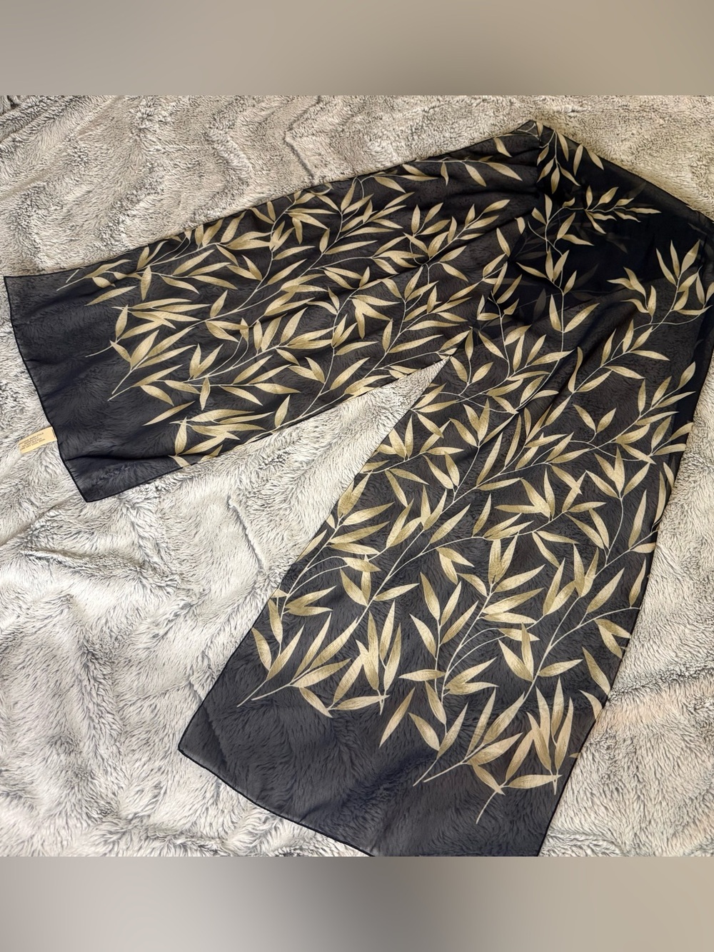 Sheer oblong rescarf with a delicate bamboo leaf print with a black backgroun